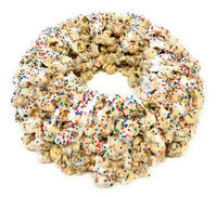 birthday popcorn cake with chocolate drizzle